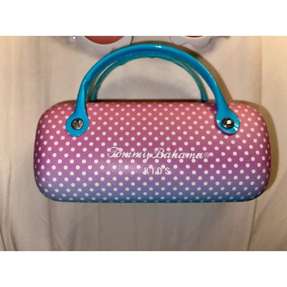 Tommy Bahama Kids sunglasses with pink to purple gradient and white polka dots.